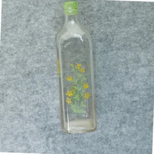 Gammel flaske vase med blomstermotiv (str. 27 x 7 cm)