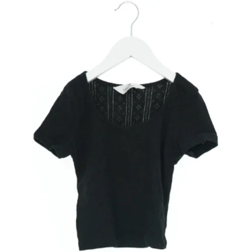 Kortærmet sort bluse med mønstret ryg fra H&M (str. 140)