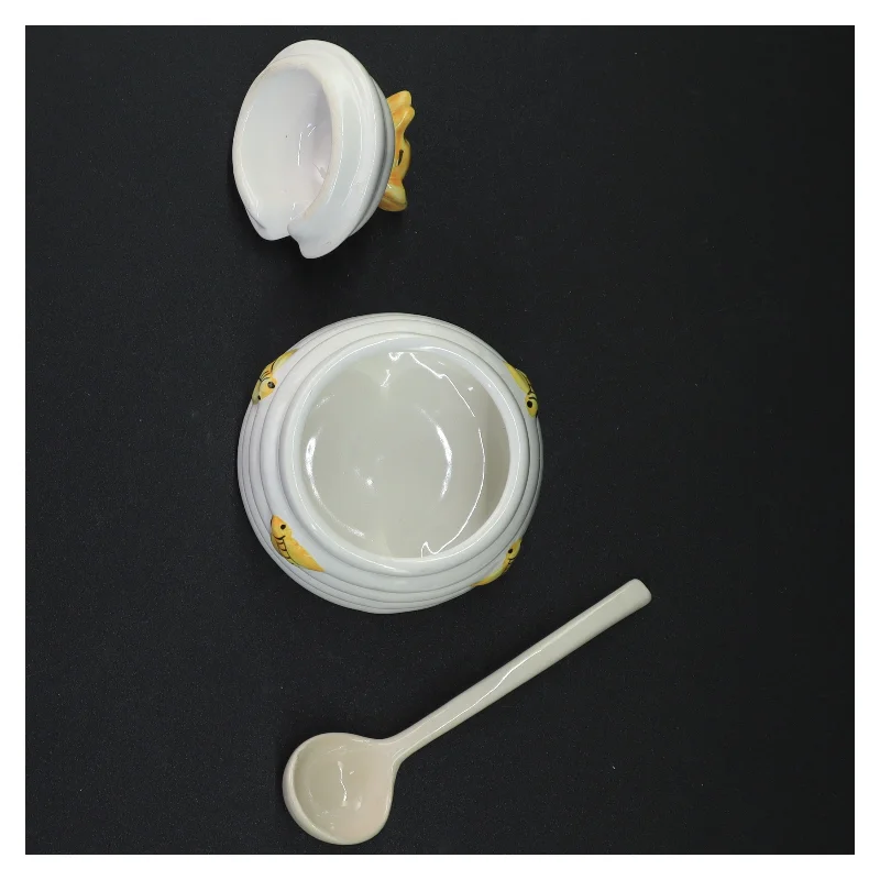 Honningkrukke med låg og ske (str. 10 komma 5 x 9 cm)