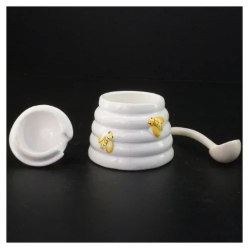 Honningkrukke med låg og ske (str. 10 komma 5 x 9 cm)