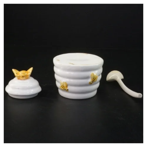 Honningkrukke med låg og ske (str. 10 komma 5 x 9 cm)