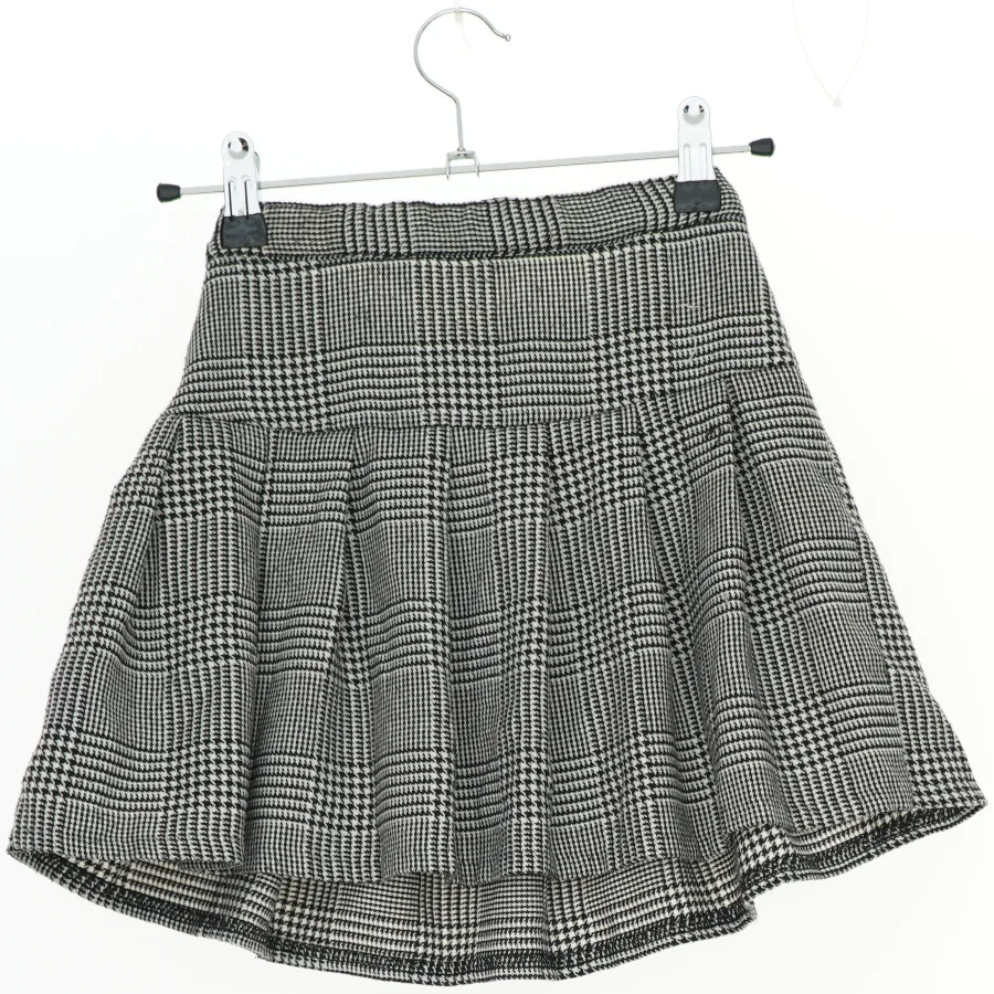 Ternet nederdel med plisseringer fra H&M (str. 134)