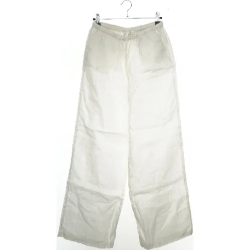 Hvide bukser i hør fra H&M (str. 158)