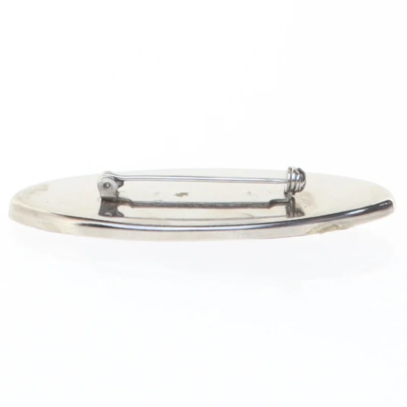 Broche i sølvfarve med lilla emalje og sten (str. 6 x 2,6 cm)