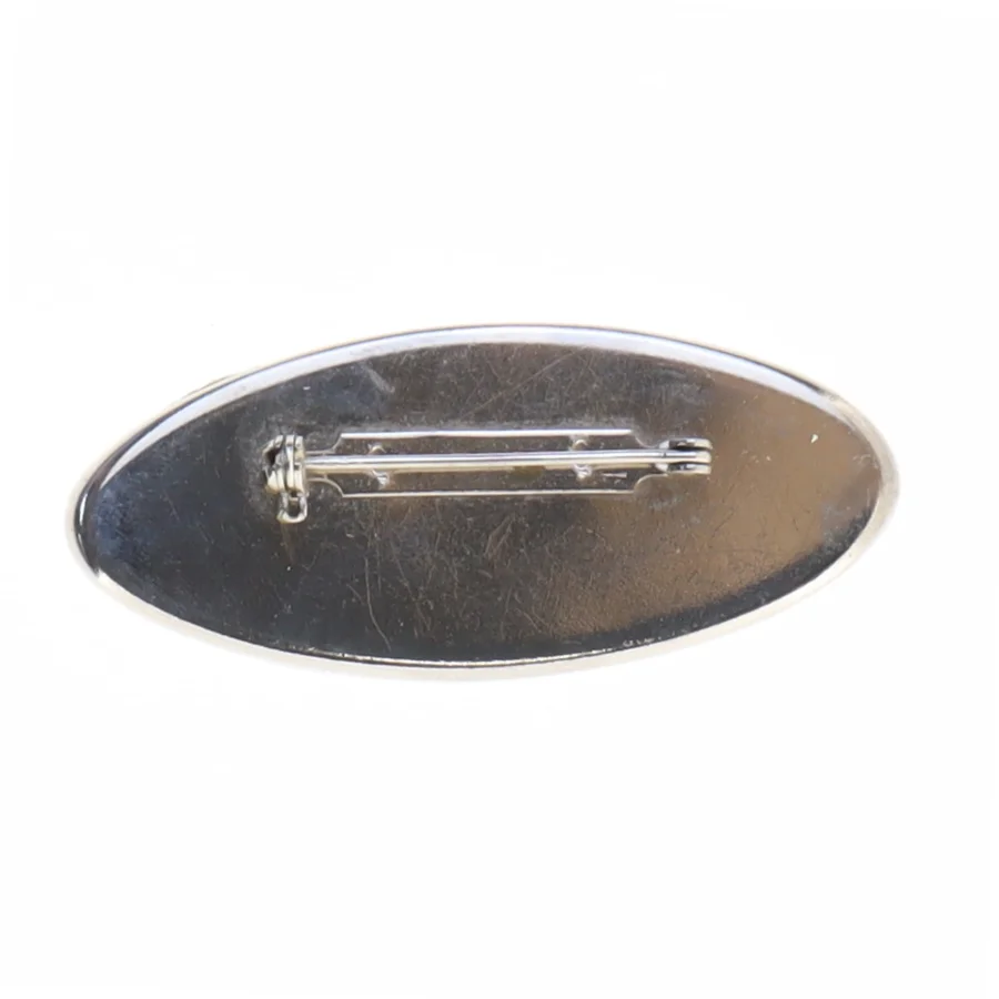 Broche i sølvfarve med lilla emalje og sten (str. 6 x 2,6 cm)