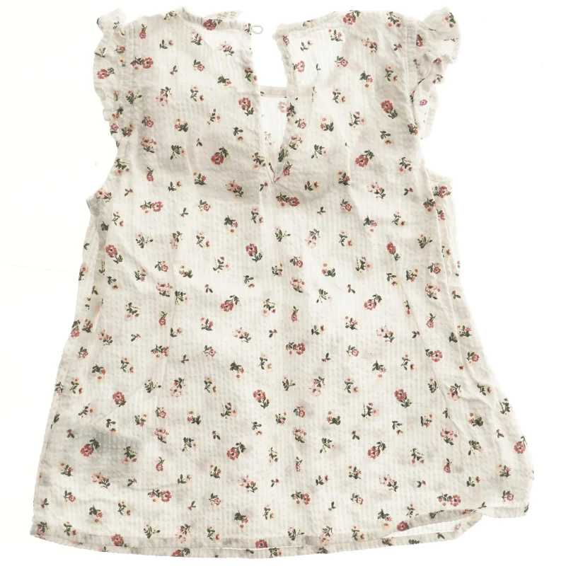 Blomstret bluse med flæser fra H&M (str. 92)