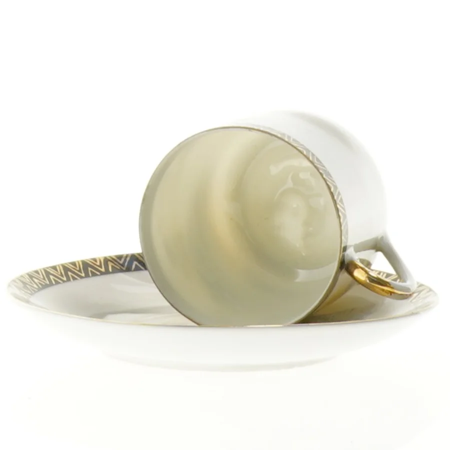 Mokkakop med ansigt i bunden 