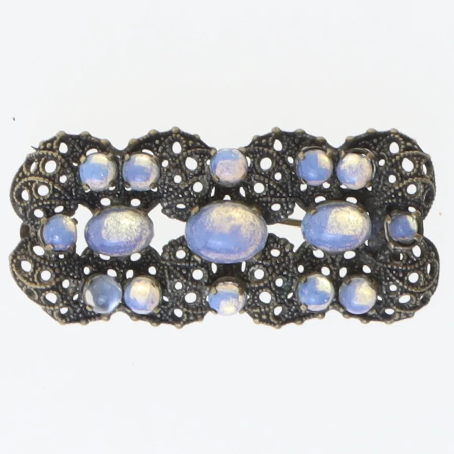 Dekorativ broche med blå sten (str. 5,5x2,5 cm)