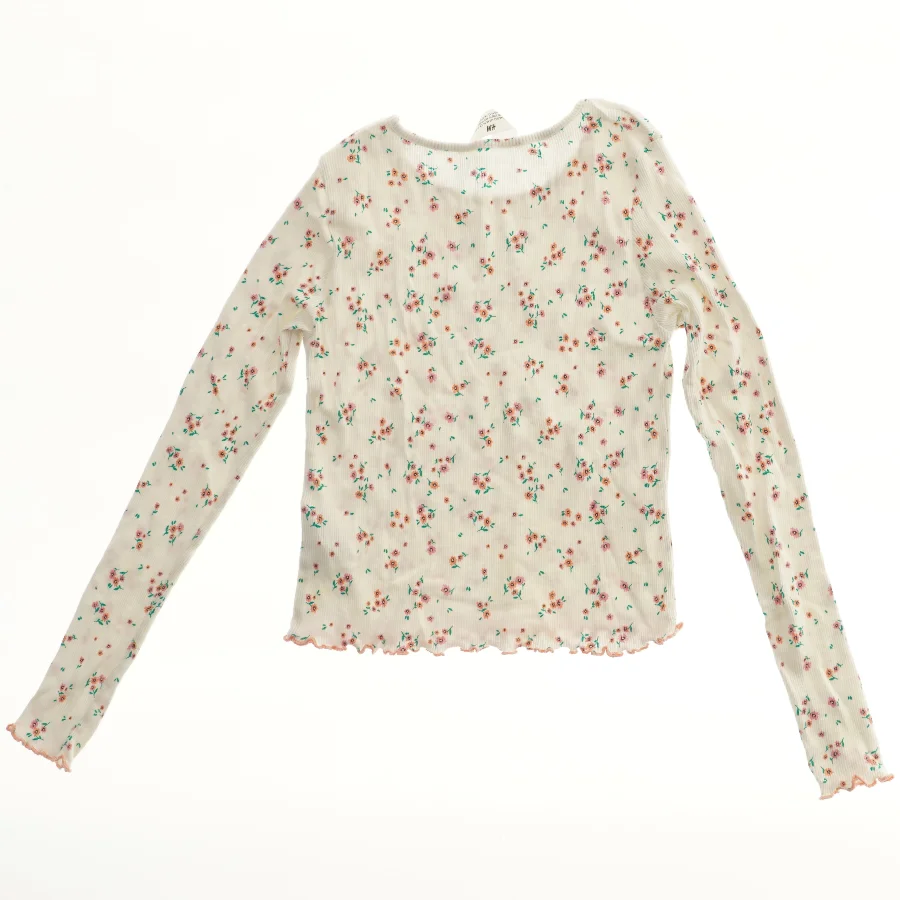 Bluse med blomsterprint fra H&M (str. 152)